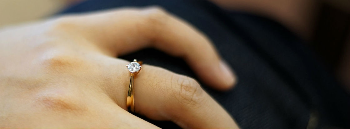 womans hand wearing cute engagement ring desktop